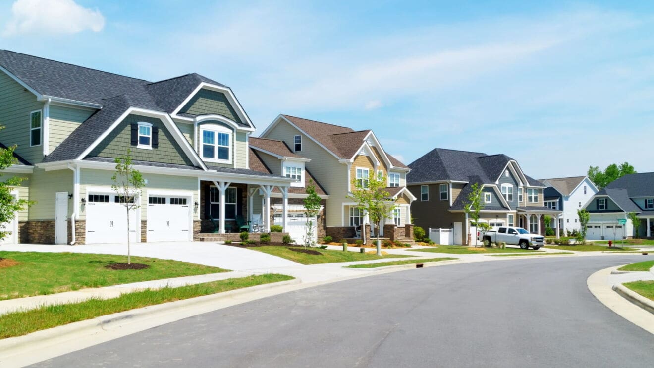 Detached suburban homes with landscaped lawns representing Niagara Falls neighbourhoods.